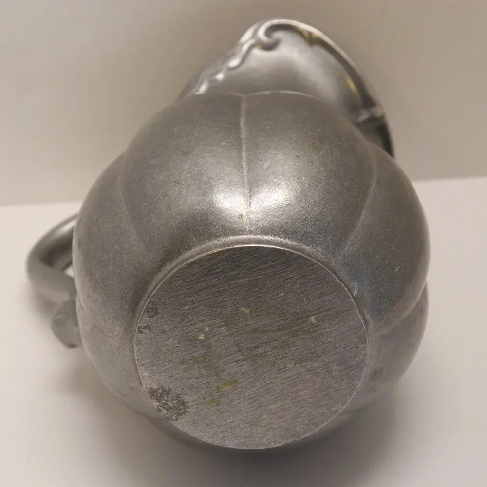 A Heavy Pewter Water Pitcher Pre Owner with some signs of wear